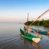 Picture of a fisherman and two boats on a lake